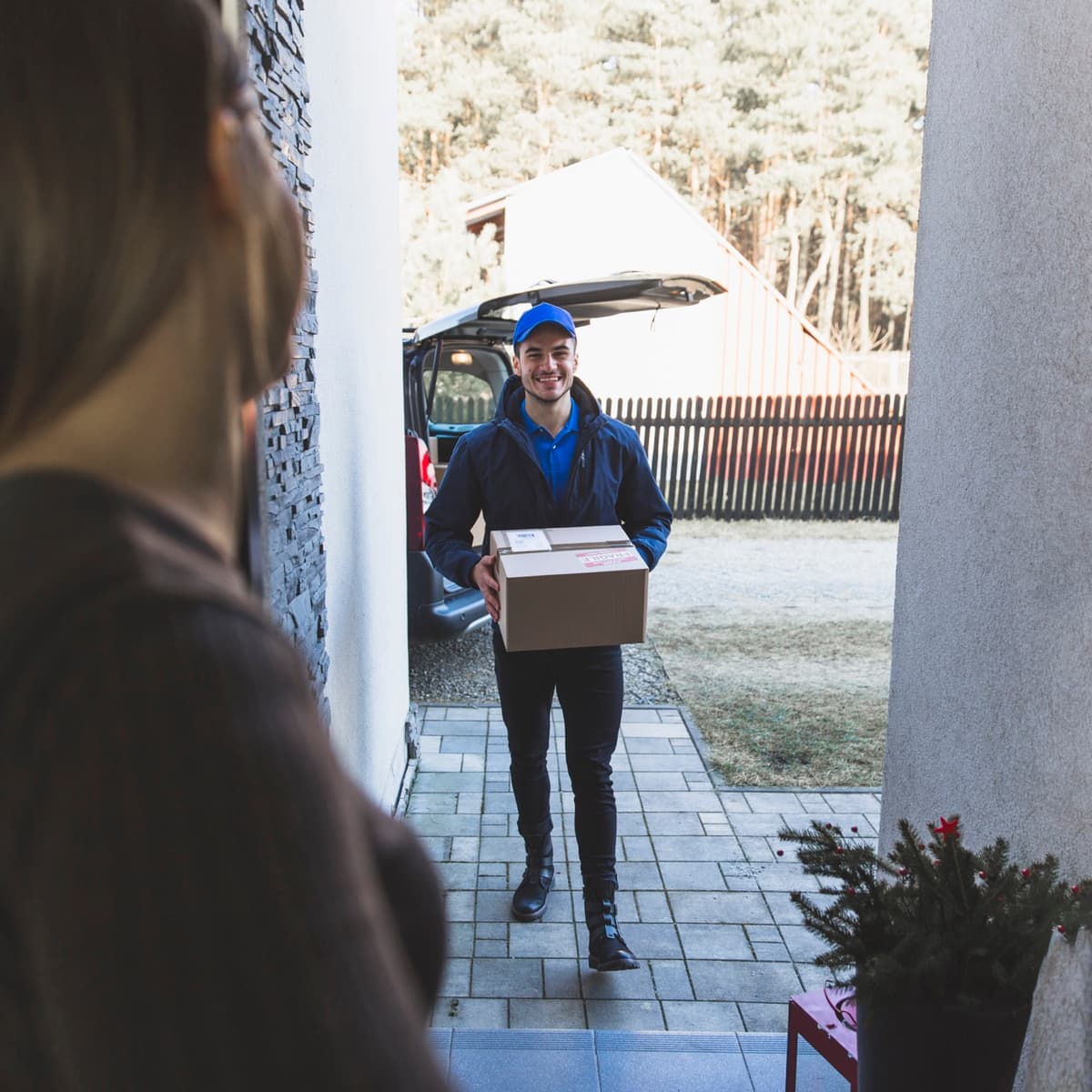 Courier delivering a parcel to a customer's door